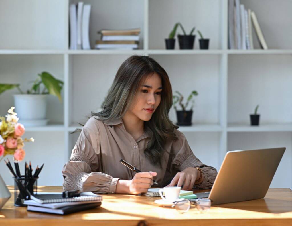 Woman reviewing documents in natural light workspace